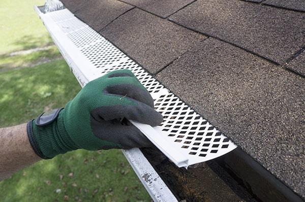 gutter guards are designed to allow water to flow into the gutters while keeping leaves, twigs, and other debris out