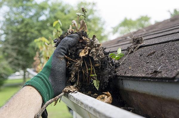 overflowing water, sagging gutters, and the presence of plants or vegetation are all signs that gutter cleaning is necessary